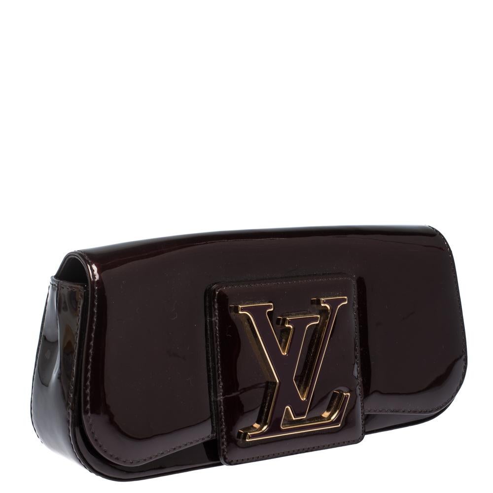 Well-crafted and overflowing with style this Sobe clutch is from Louis Vuitton. It has a patent leather exterior, a fabric interior and a large LV adorned on the flap. This creation will lift all your gowns and elegant outfits.

Includes
Original