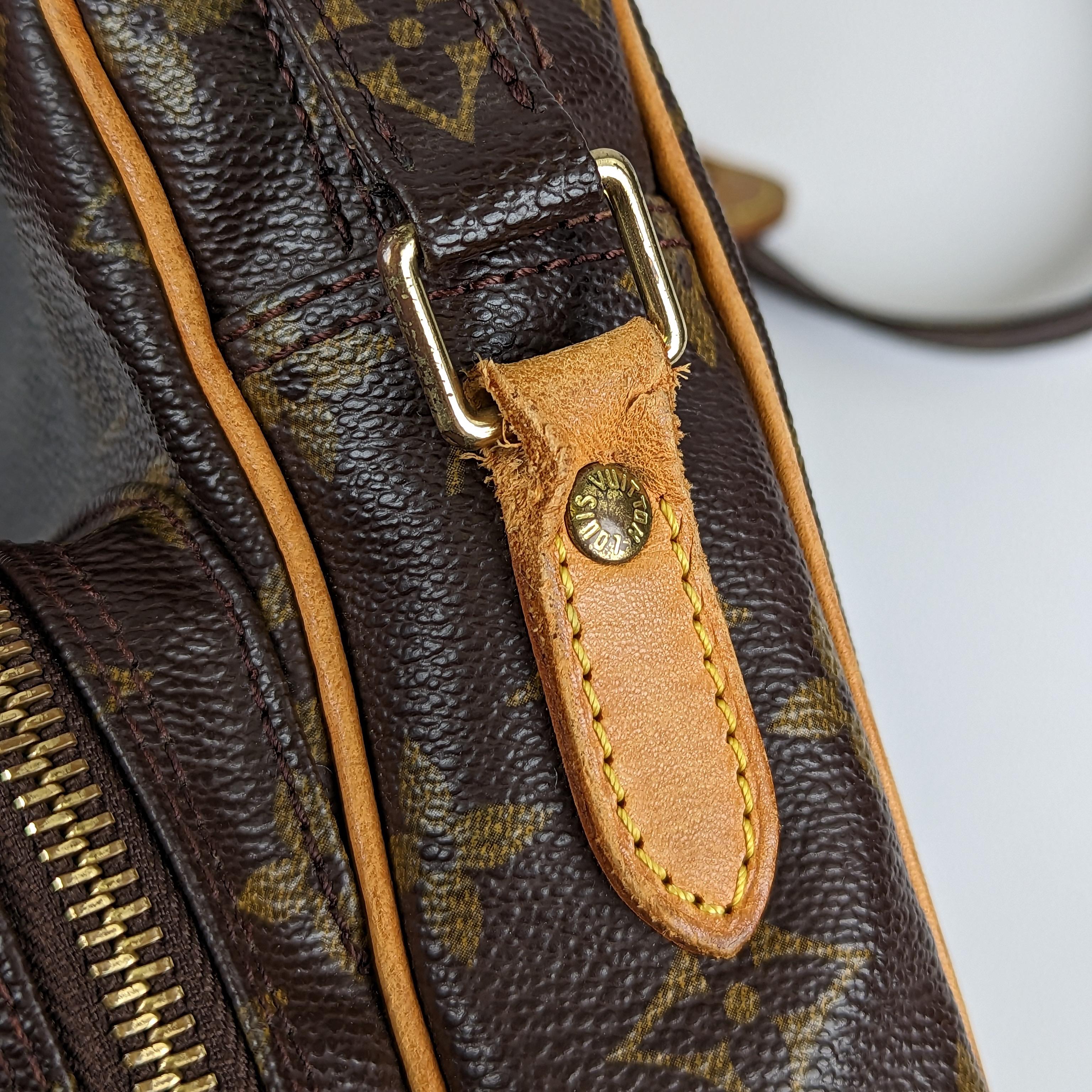 The Louis Vuitton Monogram Canvas Amazone bag is perfect for daytime style. The square shape of the Amazon is reminiscent of classic camera bags. 

The outer canvas is clean and beautiful. 

Leather trim is a medium honey patina with  light