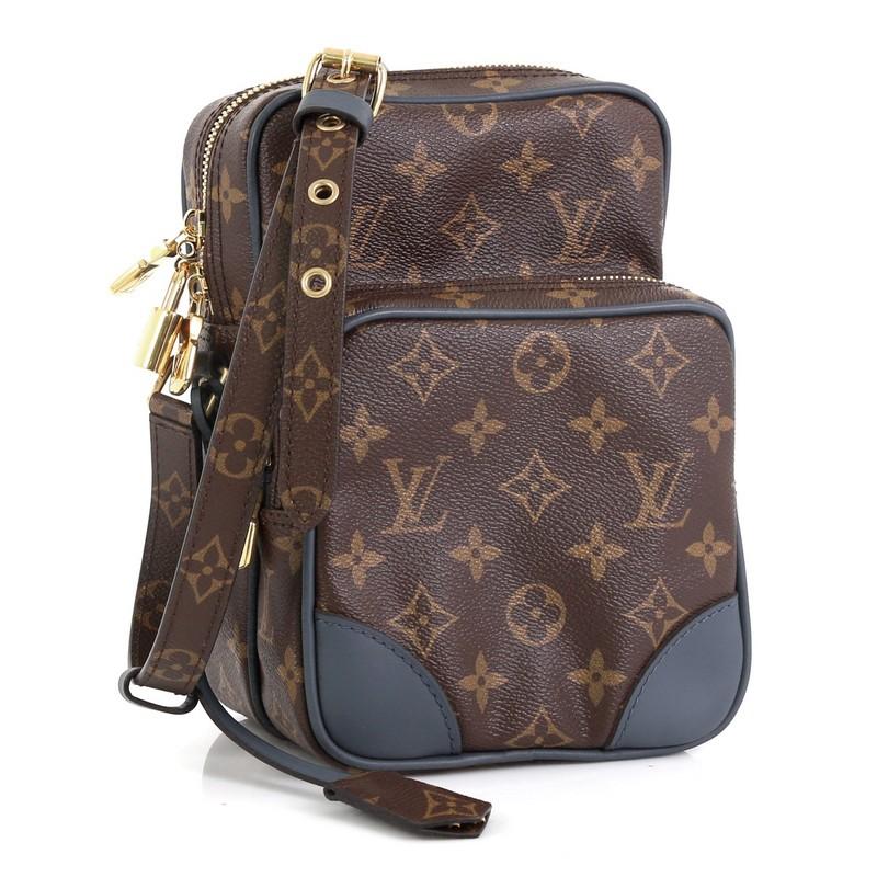 This Louis Vuitton Amazone Bag Limited Edition Monogram Slate Canvas, crafted in brown monogram coated canvas, features long adjustable strap with leather pads, front zip pocket and gold-tone hardware. Its top zip closure opens to a blue fabric