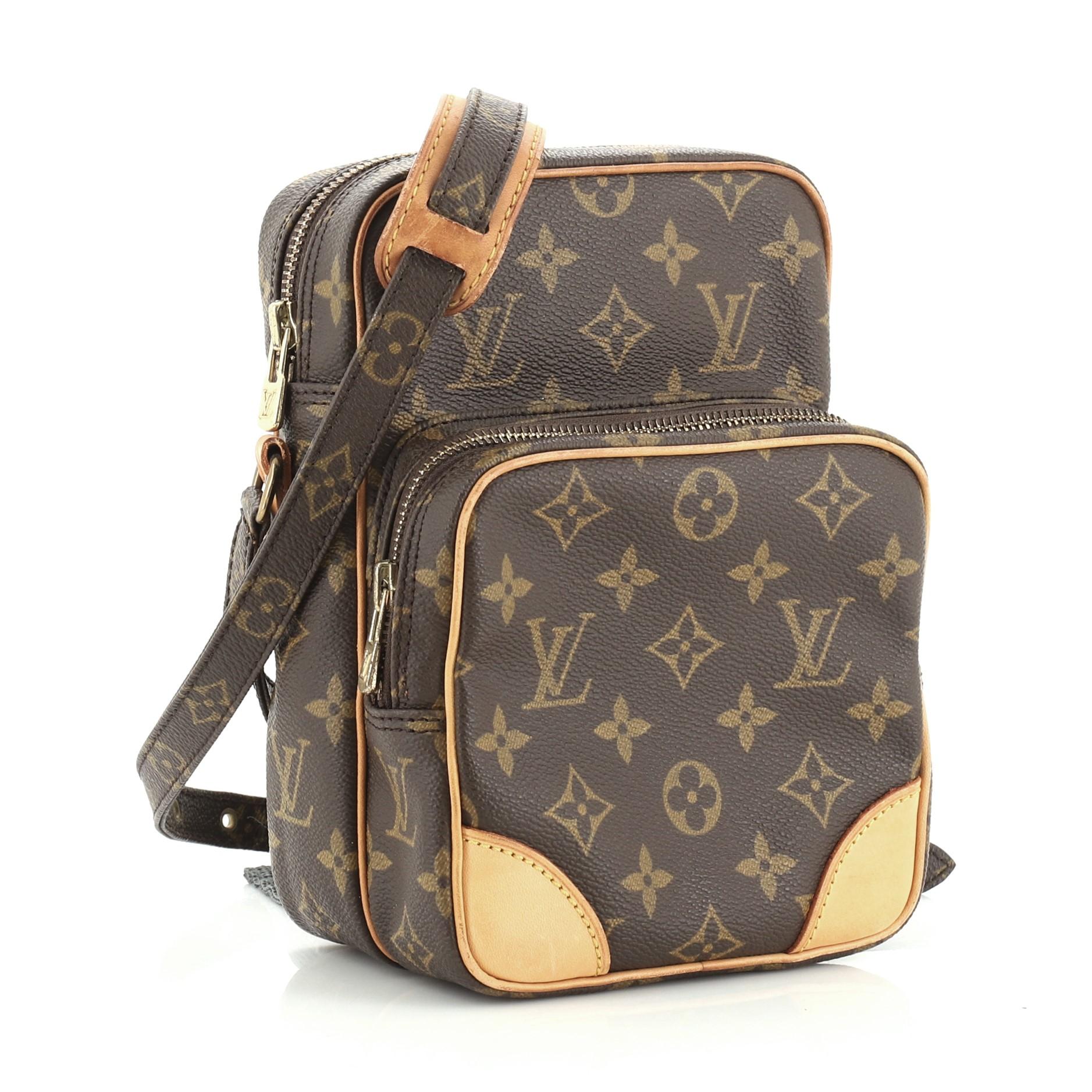 This Louis Vuitton Amazone Bag Monogram Canvas, crafted with brown monogram coated canvas, features an adjustable strap, front zip pocket and gold-tone hardware. Its top zip closure opens to a brown leather interior with slip pocket. Authenticity