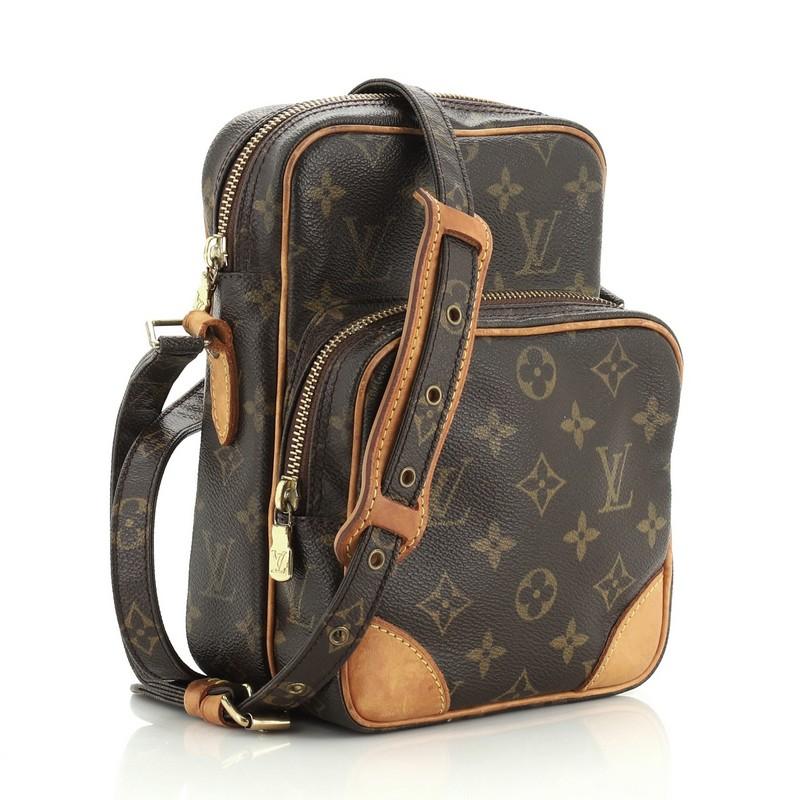 This Louis Vuitton Amazone Bag Monogram Canvas, crafted with brown monogram coated canvas, features an adjustable strap, front zip pocket and gold-tone hardware. Its top zip closure opens to a brown leather interior with slip pocket. Authenticity