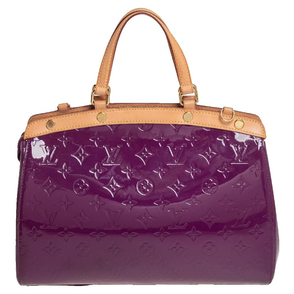 The feminine shape of Louis Vuitton's Brea is inspired by the doctor's bag. Crafted from Monogram Vernis in Amethyst, the bag has a perfect finish. The canvas interior is spacious and it is secured by a zipper. The bag features double handles,