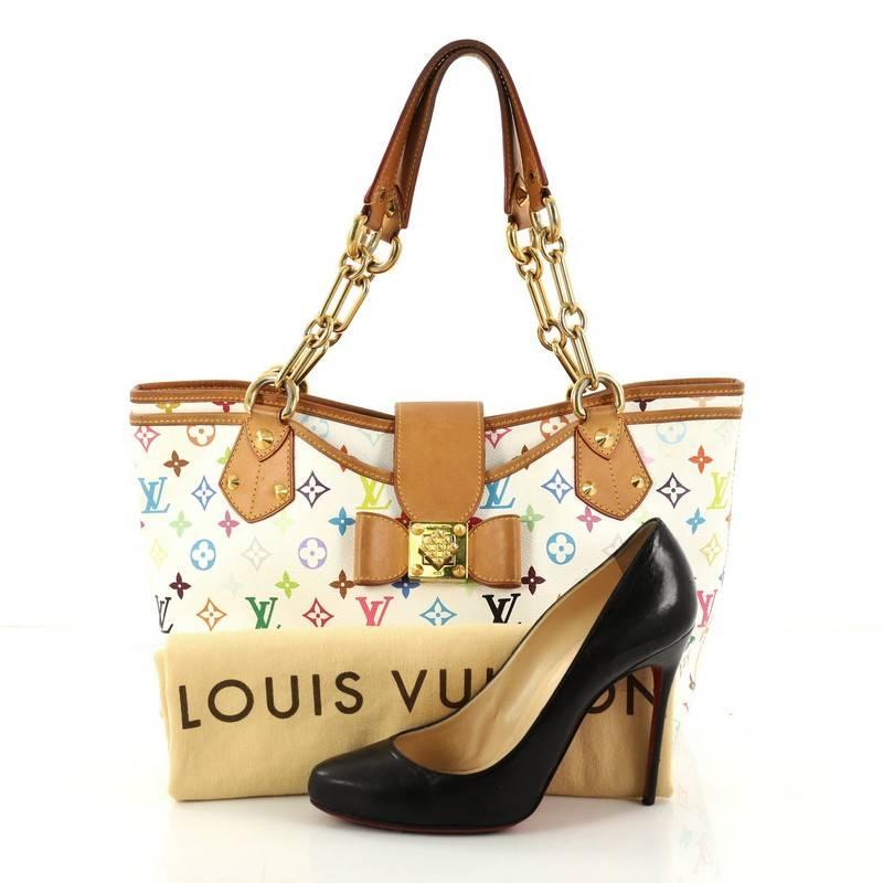 This authentic Louis Vuitton Annie Handbag Monogram Multicolor GM is a unique and rare piece perfect for modern fashionistas. Crafted in white monogram multicolor coated canvas, this tote features dual leather straps with gold chain links, natural