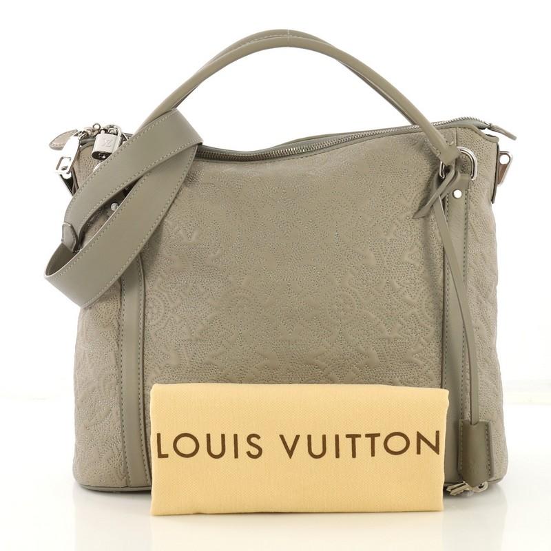 This Louis Vuitton Antheia Ixia Handbag Leather PM, crafted in gray leather, features dual rolled leather handles, stitched monogram flower patterns, and silver-tone hardware. Its zip closure opens to a dark gray microfiber interior with zip and