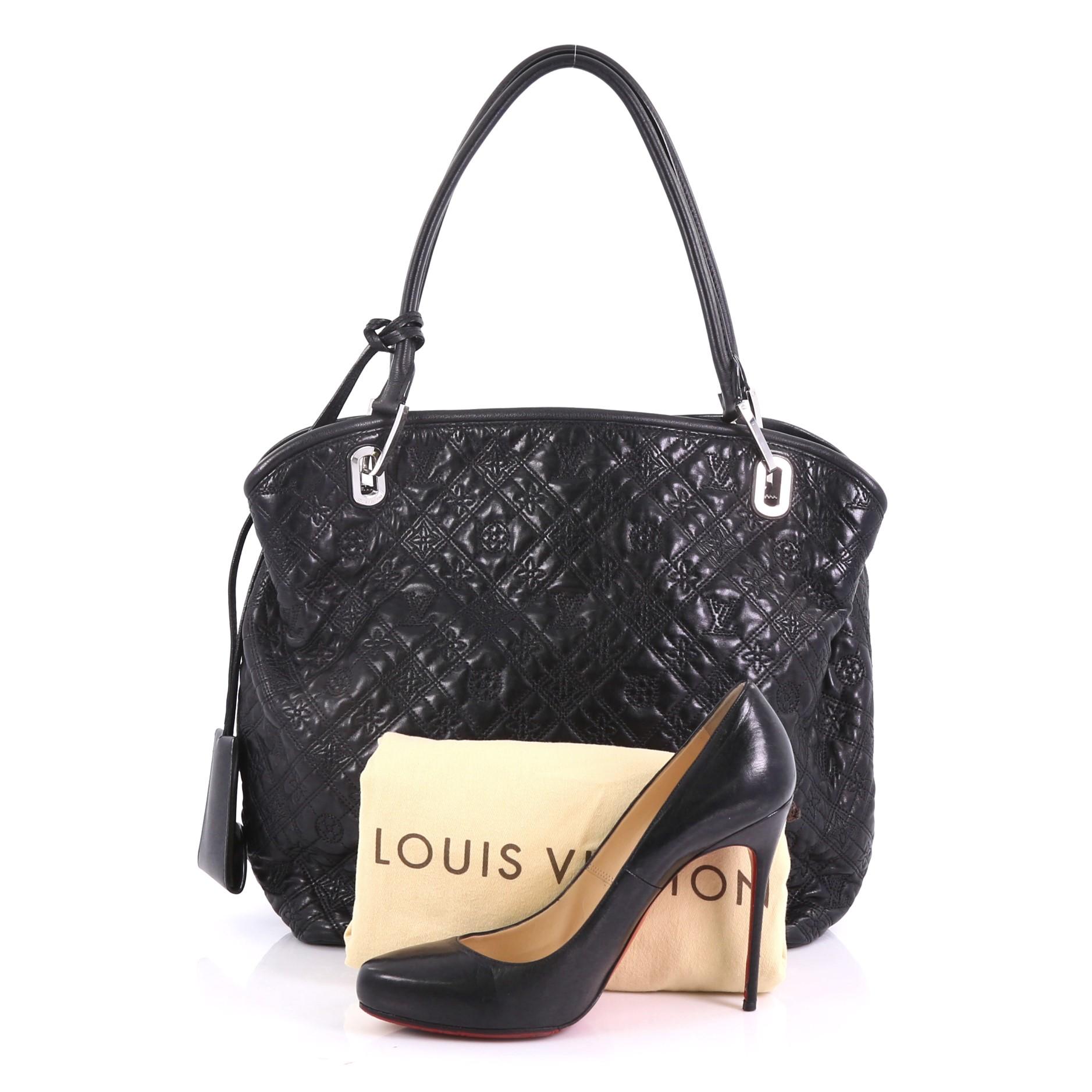 This Louis Vuitton Antheia Lilia Handbag Leather GM, crafted from black monogram antheia embroidered leather, features dual rolled leather handles, decorative padlock, and silver-tone hardware. It opens to a black microfiber interior with a center