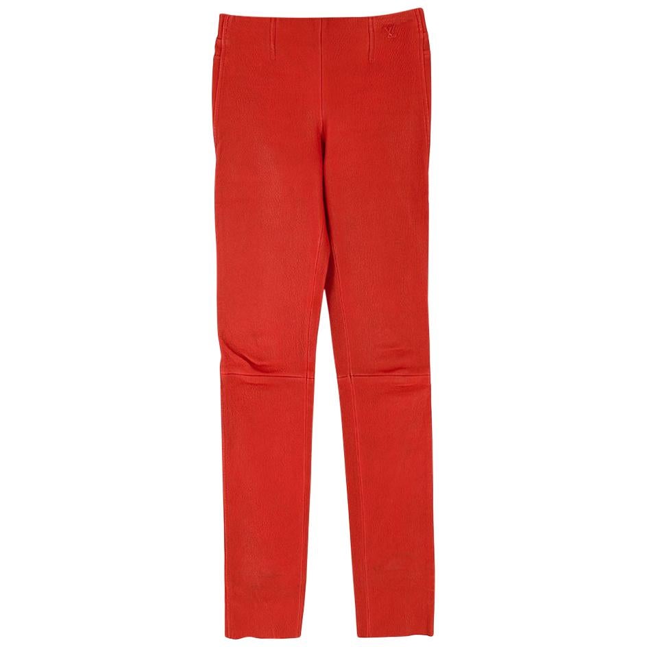 Louis Vuitton Apple Red Leather High-Waisted Trousers 

- Soft textured red leather 
- High-waisted style 
- Skinny fit 
- Sewn LV emblem on hips 
- Slip on style 

Materials: 
100% Lambskin leather

Specialist leather dry clean only 

Made in