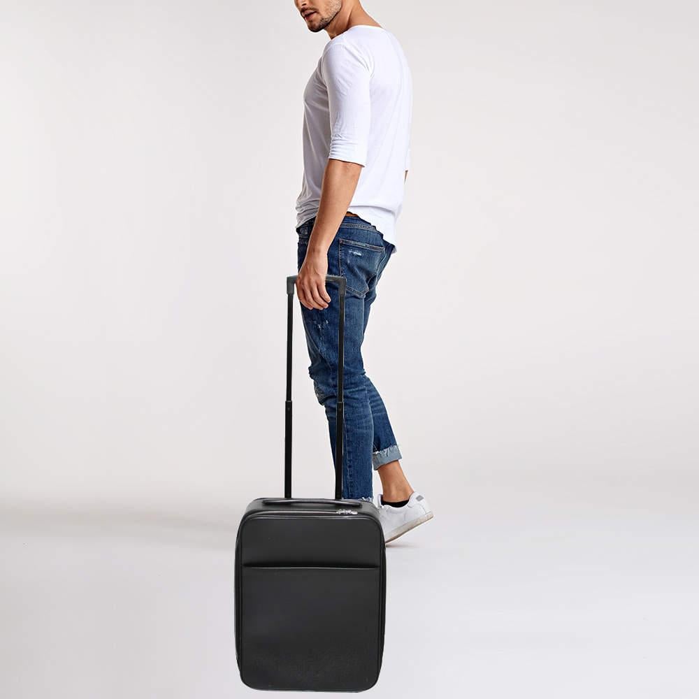 This Pegase 45 Business luggage from Louis Vuitton is super sturdy, practical, and stylish for long vacations. Crafted from Ardoise Taiga leather, this luggage bag displays silver-tone fittings, a trolley handle, and a neat nylon-lined interior. For