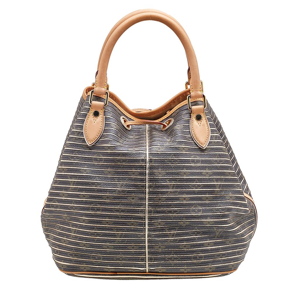 Radiate with classic style when you swing this Limited Edition Eden Neo bag from Louis Vuitton. Beautifully crafted from argent monogram canvas, and designed with a padlock on the front, this piece is a beauty. The drawstring opens to a spacious