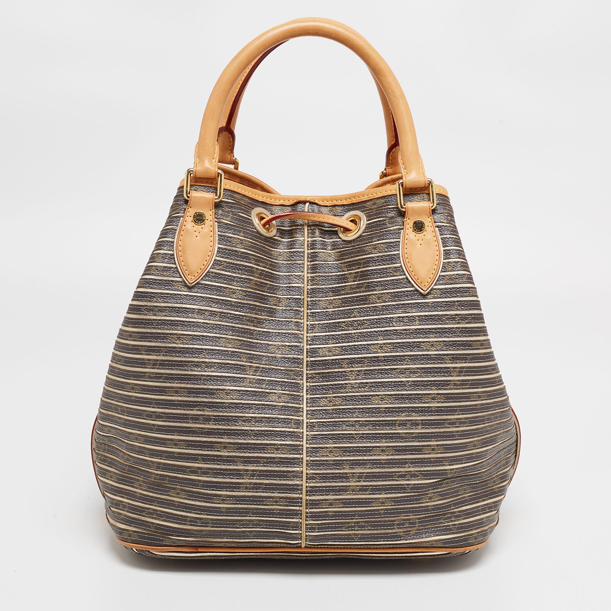 Radiate with classic style when you swing this Limited Edition Eden Neo bag from Louis Vuitton. Beautifully crafted from argent monogram canvas, and designed with a tassel charm on the front, this piece is a beauty. The drawstring opens to a