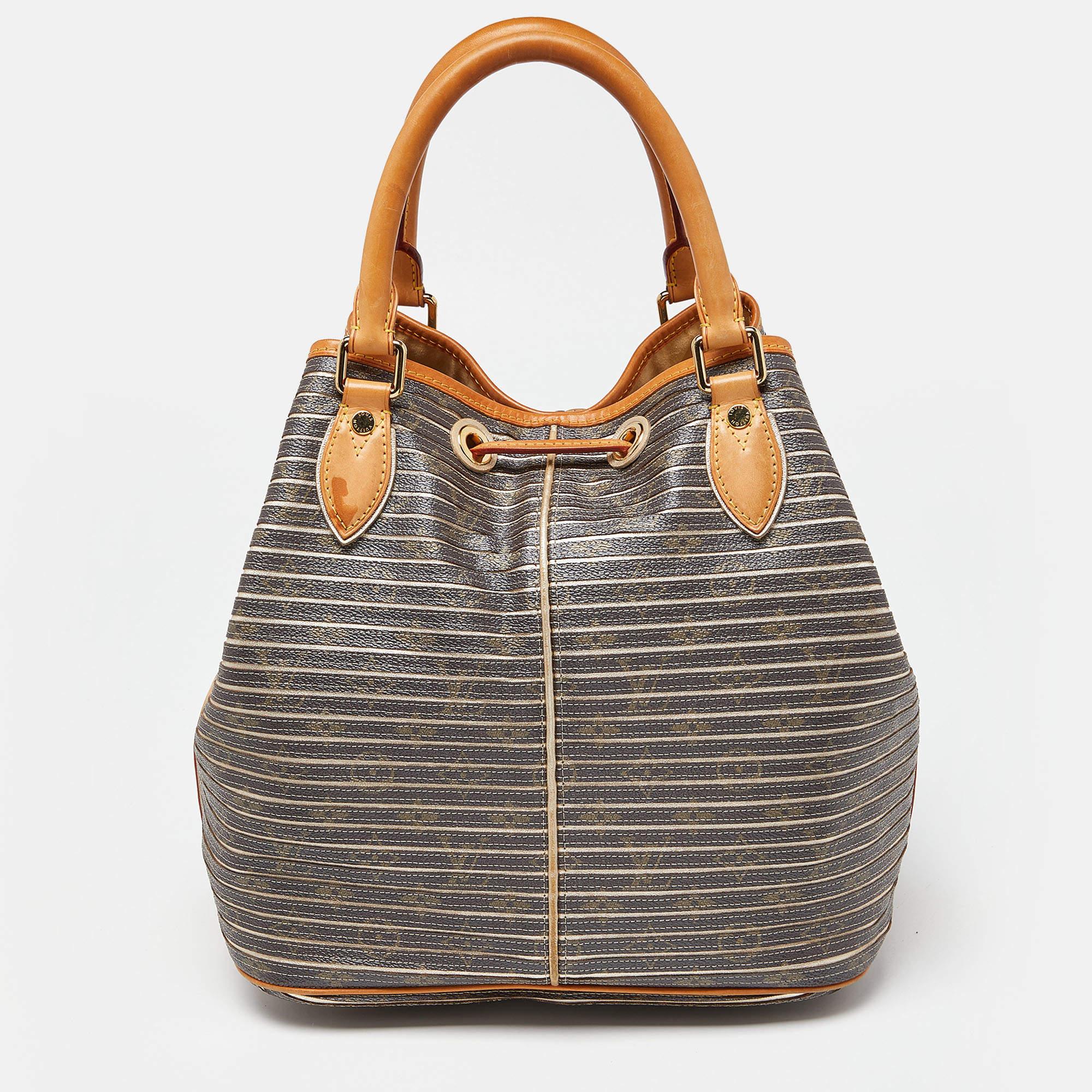 Radiate with classic style when you swing this Limited Edition Eden Neo bag from Louis Vuitton. Beautifully crafted from Argent monogram canvas, this piece is a beauty. The drawstring opens to a spacious Alcantara interior and the bag is held by two