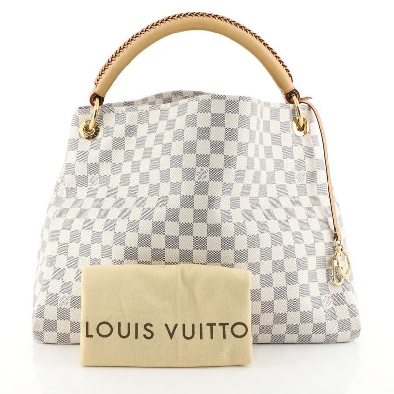 This Louis Vuitton Artsy Handbag Damier MM, crafted from damier azur coated canvas, features a rolled leather handle with braided detailing, protective base studs, and gold-tone hardware. It opens to a neutral microfiber interior with side zip and