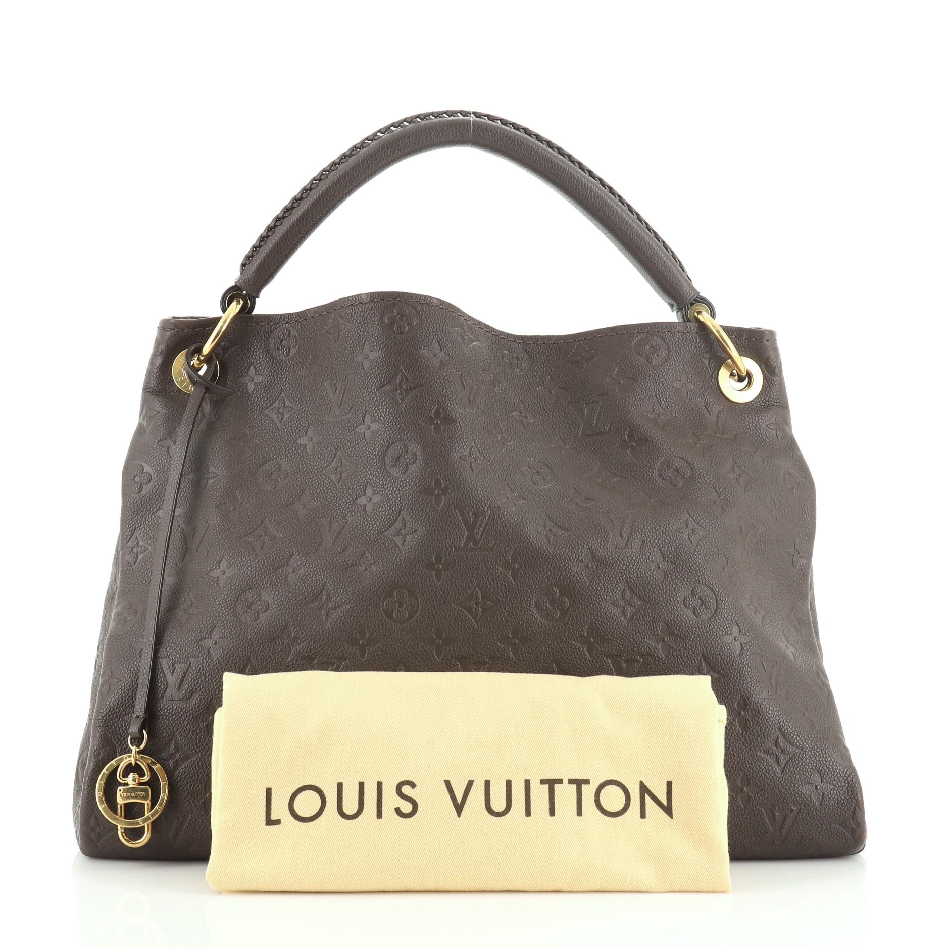 This Louis Vuitton Artsy Handbag Monogram Empreinte Leather MM, is an ideal everyday piece refined by its craftsmanship and functional features. Crafted from brown monogram empreinte leather, features a single looped braided top handle, protective