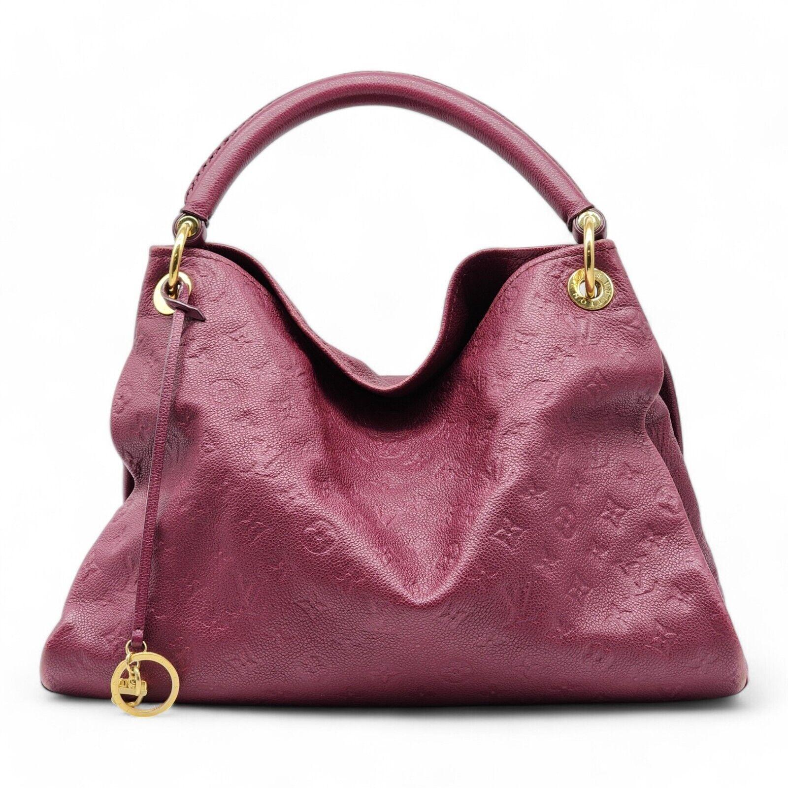 Louis Vuitton Artsy MM Empreinte LV Monogram Bag.

Louis Vuitton Top Handle Bag from the 2014 Collection by Marc Jacobs, Purple Empreinte Leather, LV Monogram, Brass Hardware, Rolled Handle, Canvas Lining & Seven Interior Pockets, Open Top,