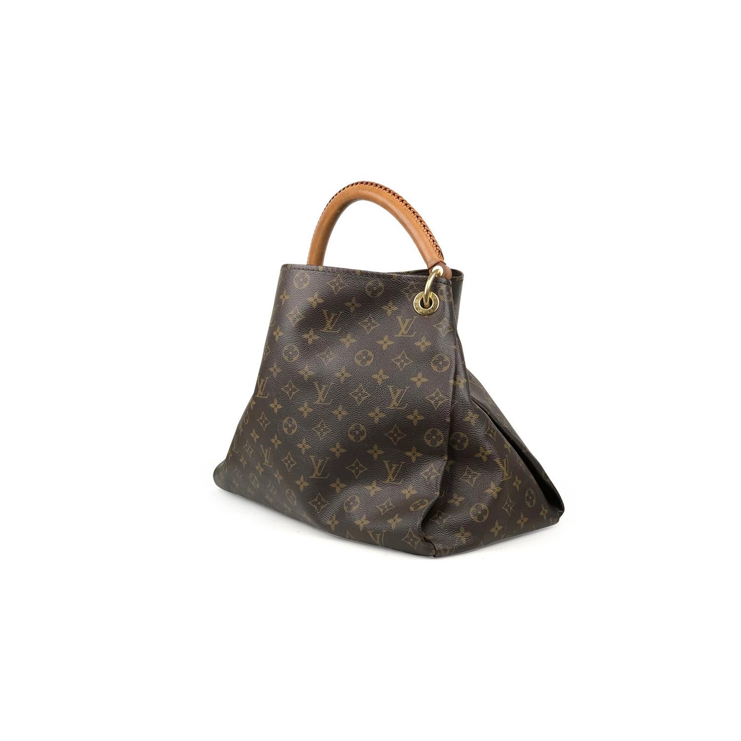 Brown and tan monogram coated canvas Louis Vuitton Artsy MM with 

– Brass hardware
– Single rolled top handle
– Tan Vachetta leather trim
– Protective feet at base, beige Alcantara lining, seven pockets at interior walls; one with zip closure and