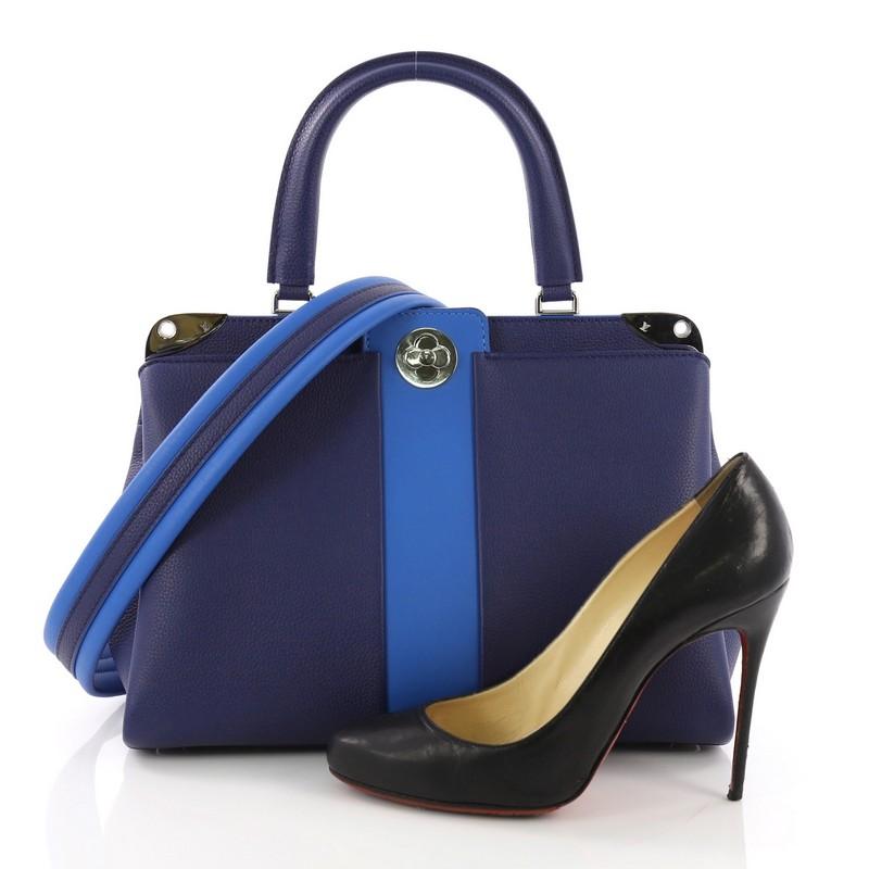 This Louis Vuitton Astrid Handbag Leather, crafted from blue leather, features a leather top handle, leather stripe at the center, silver plates at top edges, and silver-tone hardware. Its flower lock closure opens to a blue leather interior divided
