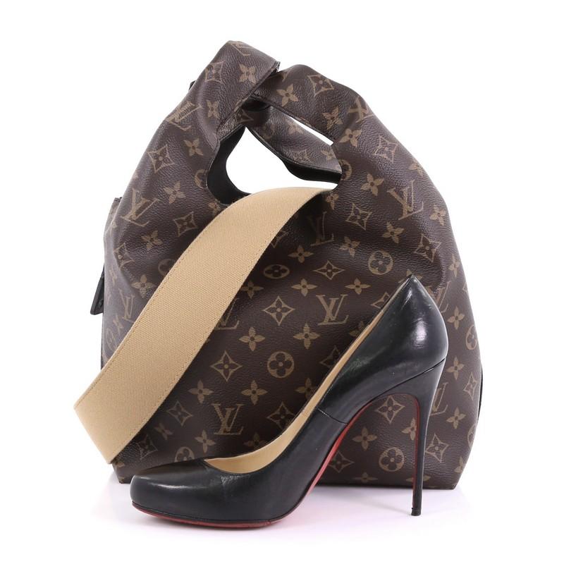 This Louis Vuitton Atlantis Handbag Monogram Canvas PM, crafted from brown monogram coated canvas, features dual looping handles, exterior side zip pocket, and gold-tone hardware. Its turn lock closure opens to a black microfiber interior with side