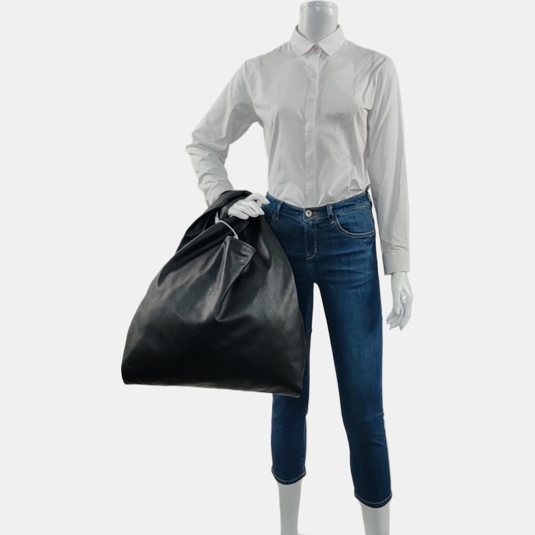 Louis Vuitton Atlantis Large Black Monogram Leather Bucket Bag with Pouch
These are professional photos of the actual bag offered by Luxbags.

2016 version crafted from softer monogram canvas than the newer version. 
CONDITION: EXCELLENT
This