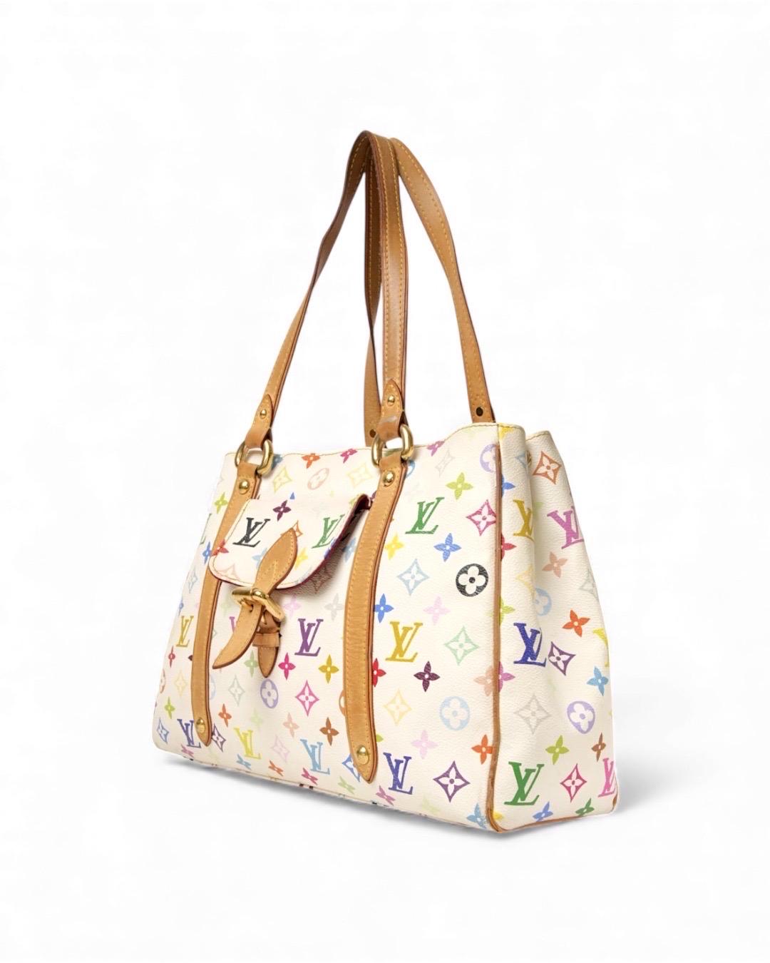 Borsa firmata Louis Vuitton, edizione limitata in collaborazione con Takashi Murakami. Modello Aurelia nella misura GM, realizzata in tela bianca nella fantasia multicolor con inserti in vacchetta  e hardware dorato. Dotata di una chiusura a gancio,