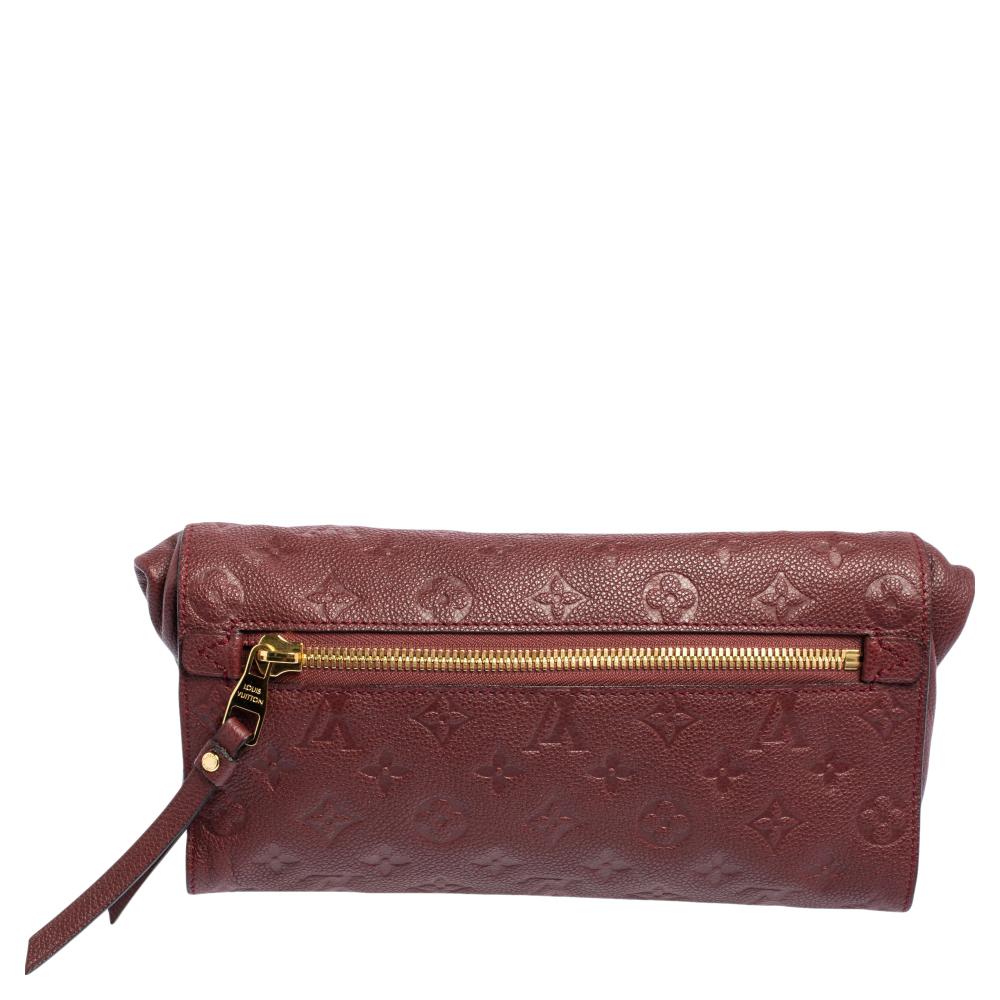 This elegant Petillante clutch from Louis Vuitton is simple in design. Crafted from Aurore Monogram Empreinte leather, the bag features a front and rear zip pocket. The classic LV monogram pattern is embossed. A gold-tone zip closure opens to a