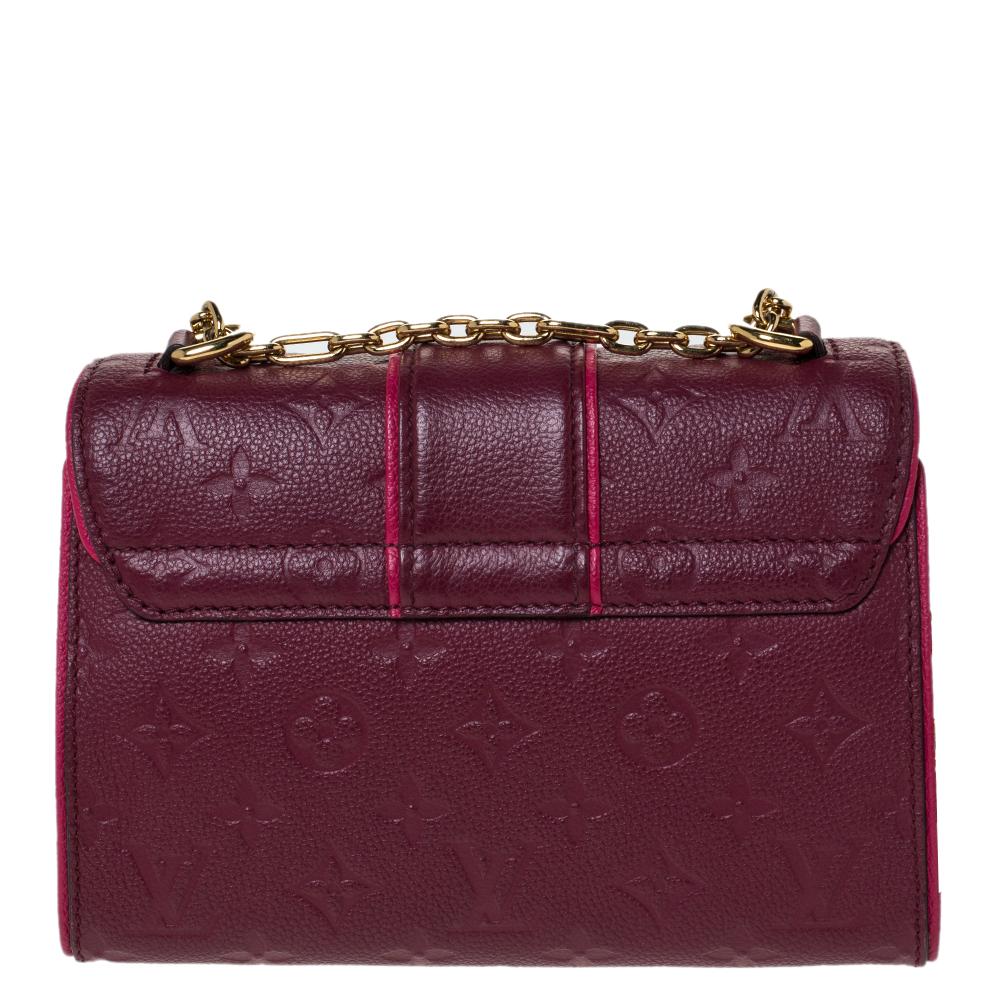 This Louis Vuitton Saint Sulpice bag carries oodles of style and sophistication. Crafted in France, it is made of Monogram Empreinte leather. It comes in a lovely shade of burgundy. It has a flap top with a gold-tone push-lock closure that