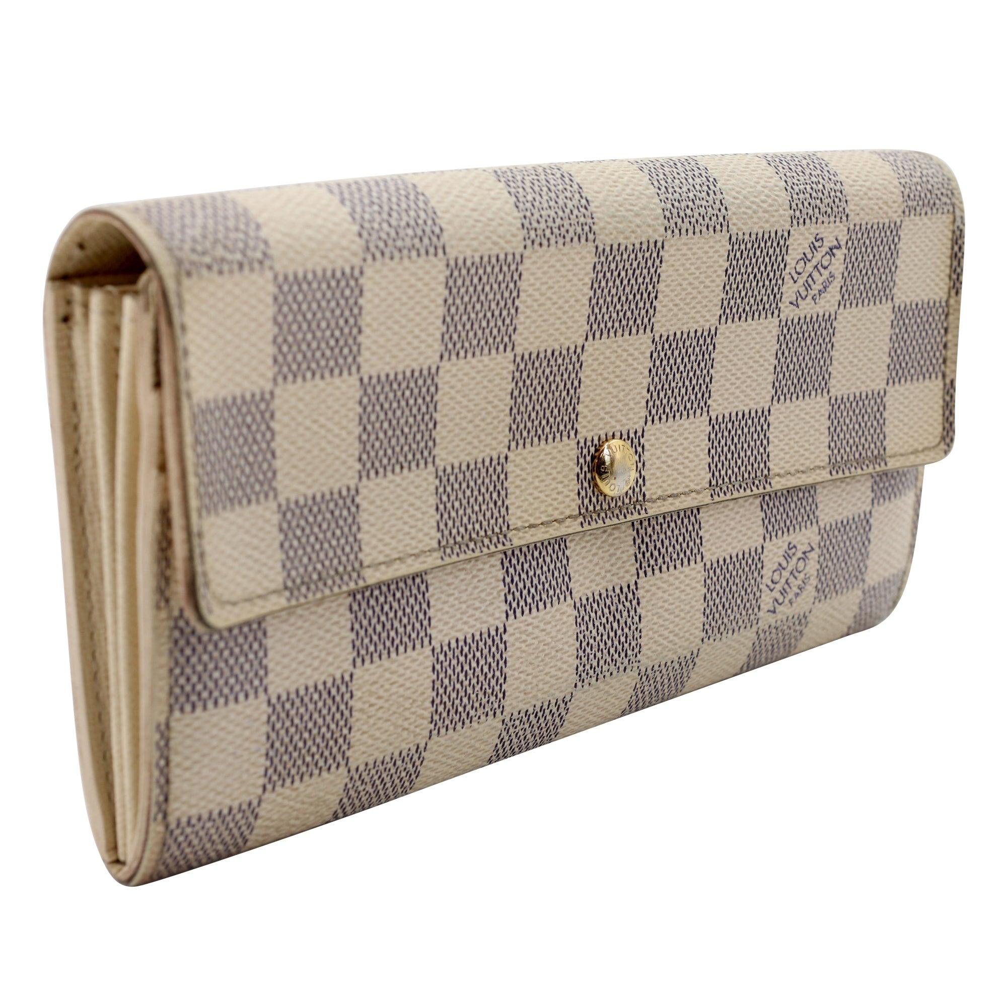 This Louis Vuitton Damier Azur Canvas Sarah Wallet is the most elegant way to organize your essentials like your bills, currency, credit cards and plenty of coins. This delightful piece will always be a popular and timeless classic. The exterior