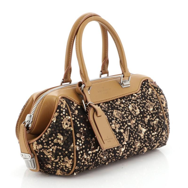 This Louis Vuitton Baby Speedy Bag Limited Edition Sunshine Express, crafted from brown textile, features dual rolled handles, protective base studs, and matte silver tone hardware. Its zip closure opens to a gold nylon interior with zip pockets.