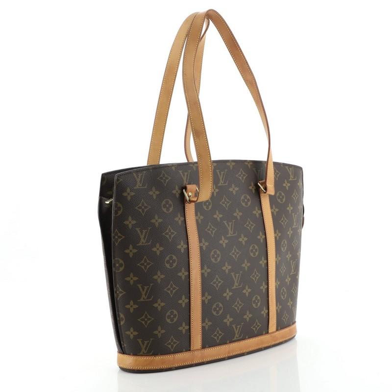 Condition: Good. Heavy darkening, wear, scuffs and watermarks on leather trims and handles, splitting on handle and zipper tab wax edges. Minor wear and small marks in interior, scratches on hardware. 
Accessories: No Accessories 
Measurements: