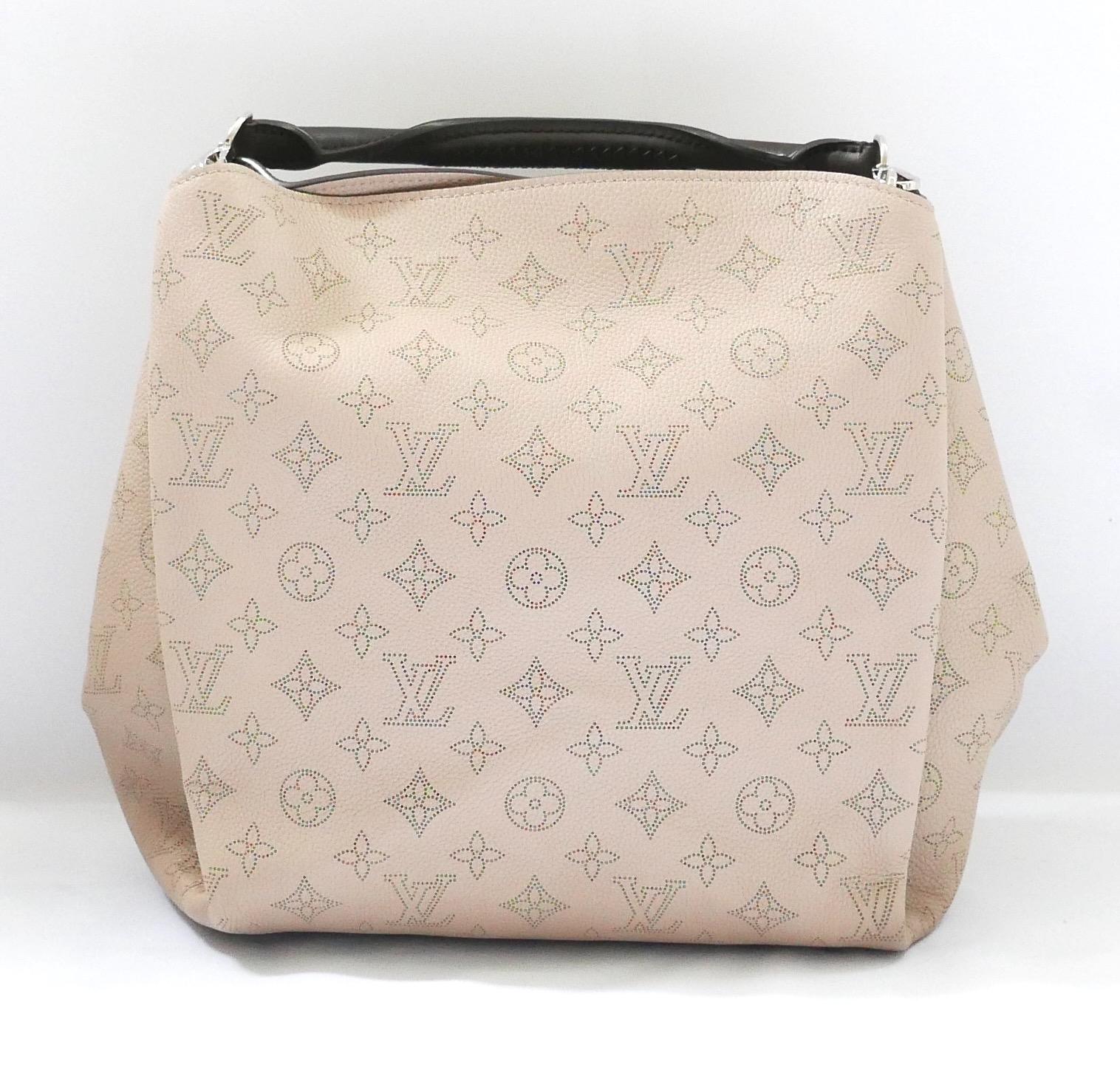 Gorgeous Louis Vuitton Babylone PM Mahina Galet bag. Unworn with dustbag, care leaflet and sticker/tag and protective covering to inner zip fob. Beautifully crafted in thick beige monogram leather, it has a chunky rolled and braided brown leather