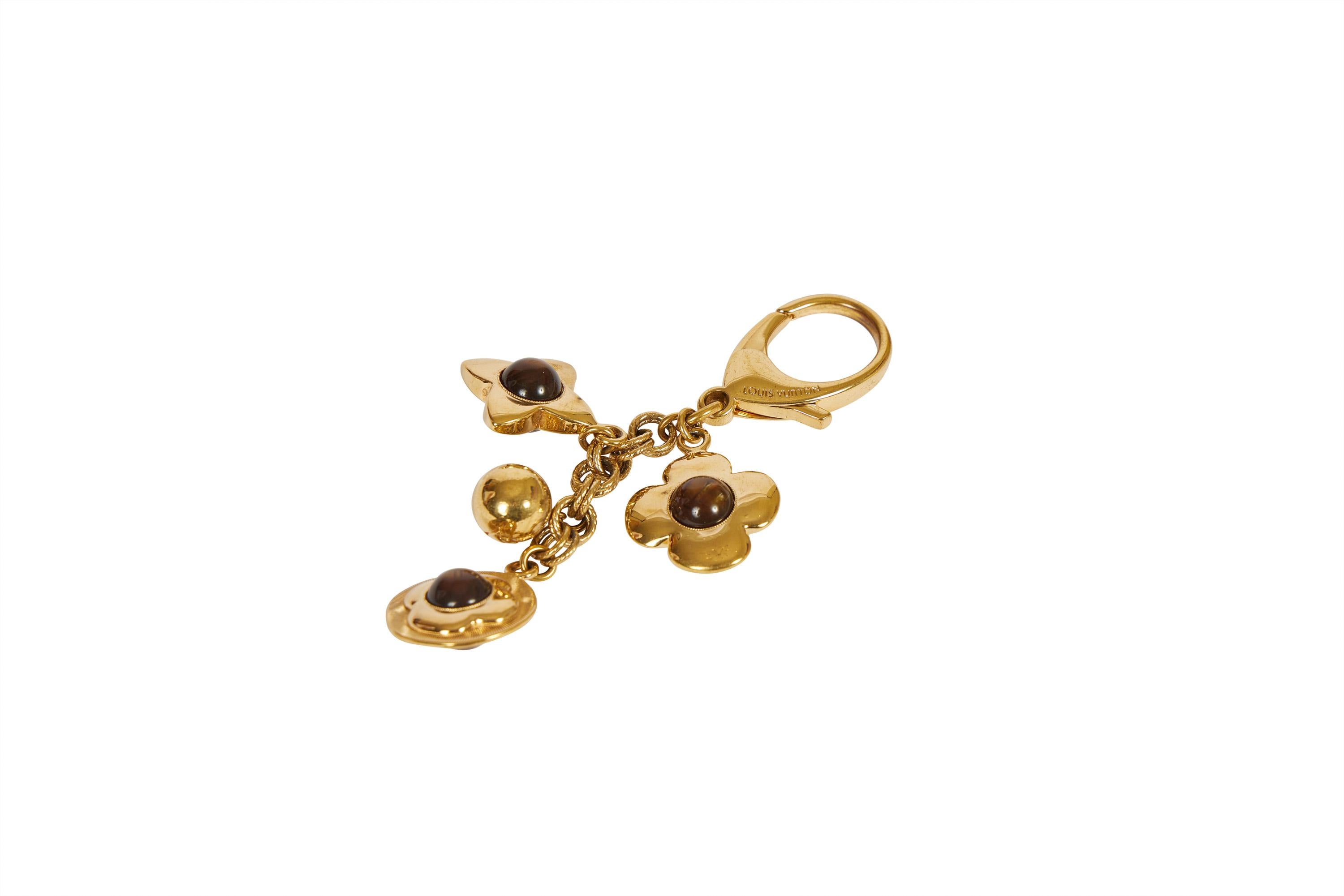 Louis Vuitton authentic bag charm /keychain with brown monogram symbols and gold tone metal. Comes with original pouch or box.
