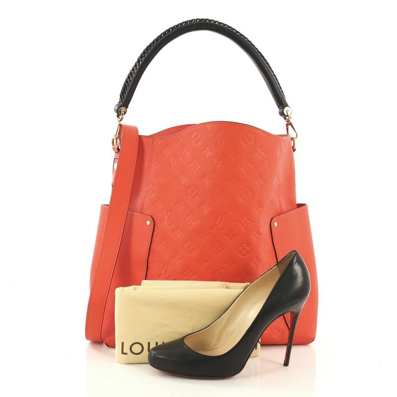 This Louis Vuitton Bagatelle Hobo Monogram Empreinte Leather, crafted from orange monogram empreinte leather, features a braided handle, exterior flat pockets on each side, and gold-tone hardware. Its wide open top showcases an orange fabric