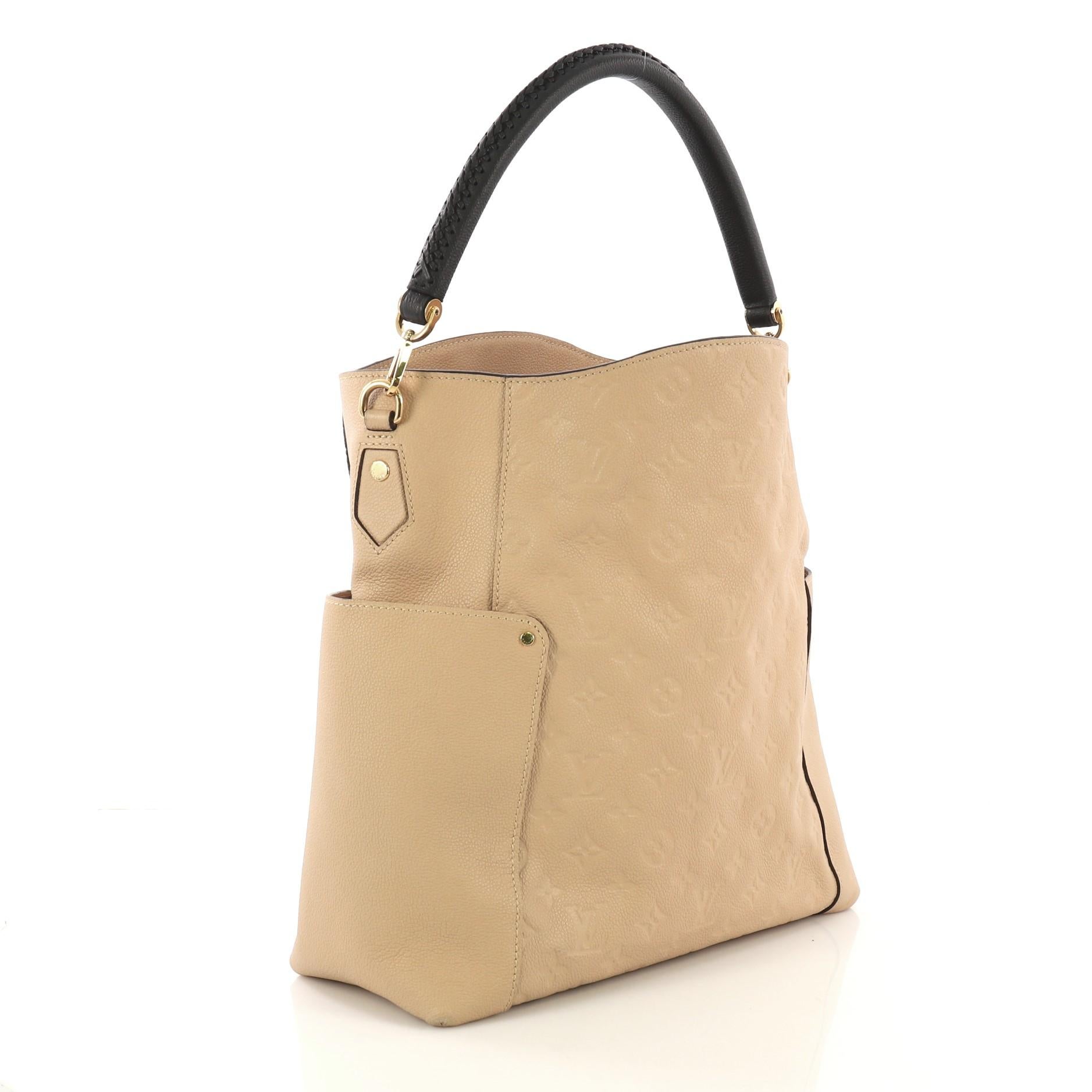 This Louis Vuitton Bagatelle Hobo Monogram Empreinte Leather, crafted from beige monogram empreinte leather, features a braided handle, exterior flat pockets on each side, and gold-tone hardware. Its wide open top showcases a beige fabric interior