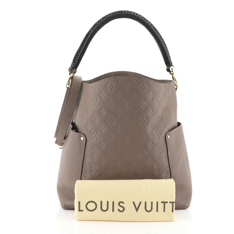 This Louis Vuitton Bagatelle Hobo Monogram Empreinte Leather, crafted from neutral monogram empreinte leather, features a braided handle, exterior flat pockets on each side, and gold-tone hardware. Its wide open top showcases a neutral fabric