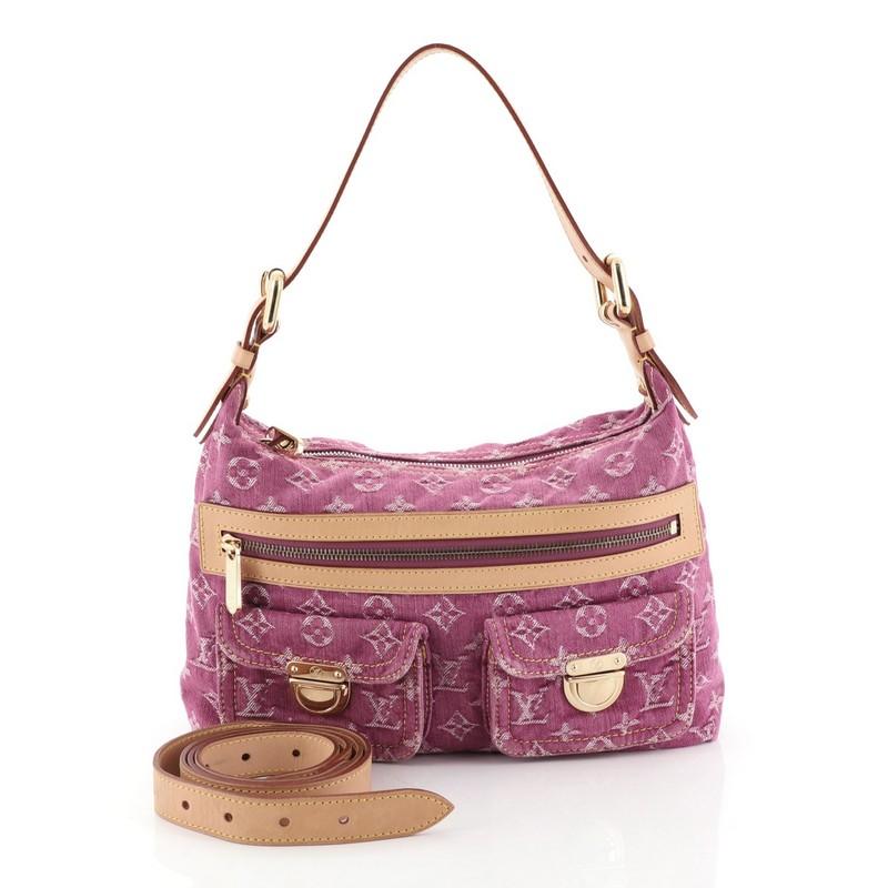 This Louis Vuitton Baggy Handbag Denim PM, crafted from pink monogram denim, features vachetta leather trim, contrast stitching, two exterior flap pockets with push-lock closure, front zip pocket, protective base studs and gold-tone hardware. Its