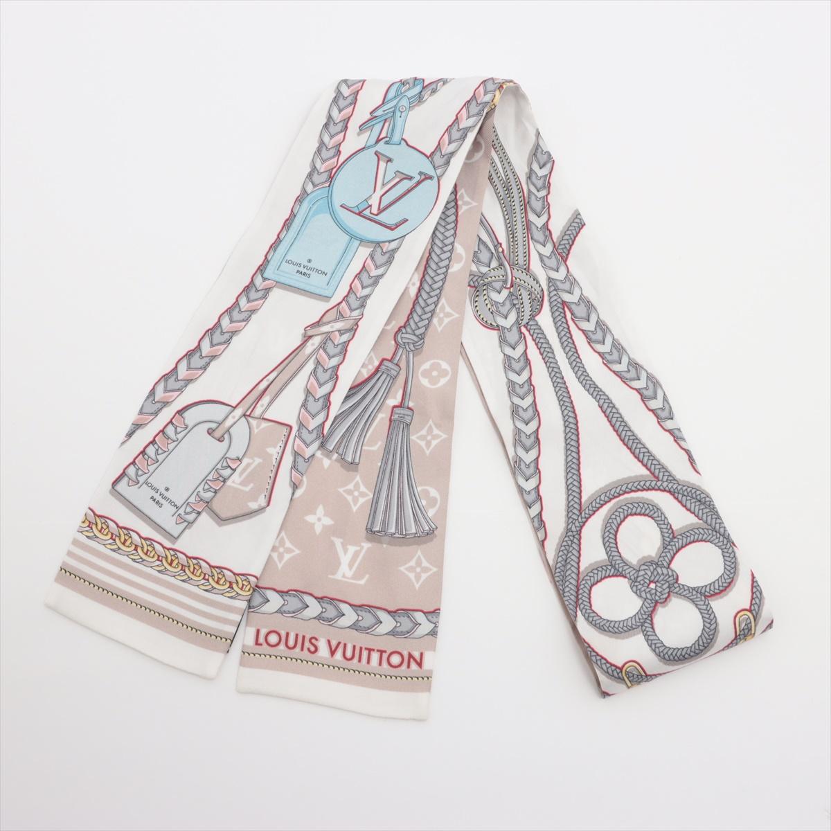 The Louis Vuitton Bandeau Mixes and Strap in Beige is a refined silk accessory that blends classic Monogram elements with intricate tassel motifs for a sophisticated aesthetic. The neutral beige color palette adds versatility, making it a timeless