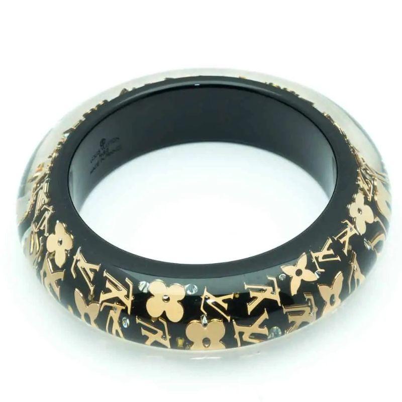 Louis Vuitton Timeless and beautiful plexi bangle made of encrusted gold monogram letters inclusion. Matching ring also available. Ask for more details.

Signed: Louis Vuitton Paris Made in France, LK0123, M
Dimensions: 2.3 W cm, inside diameter: