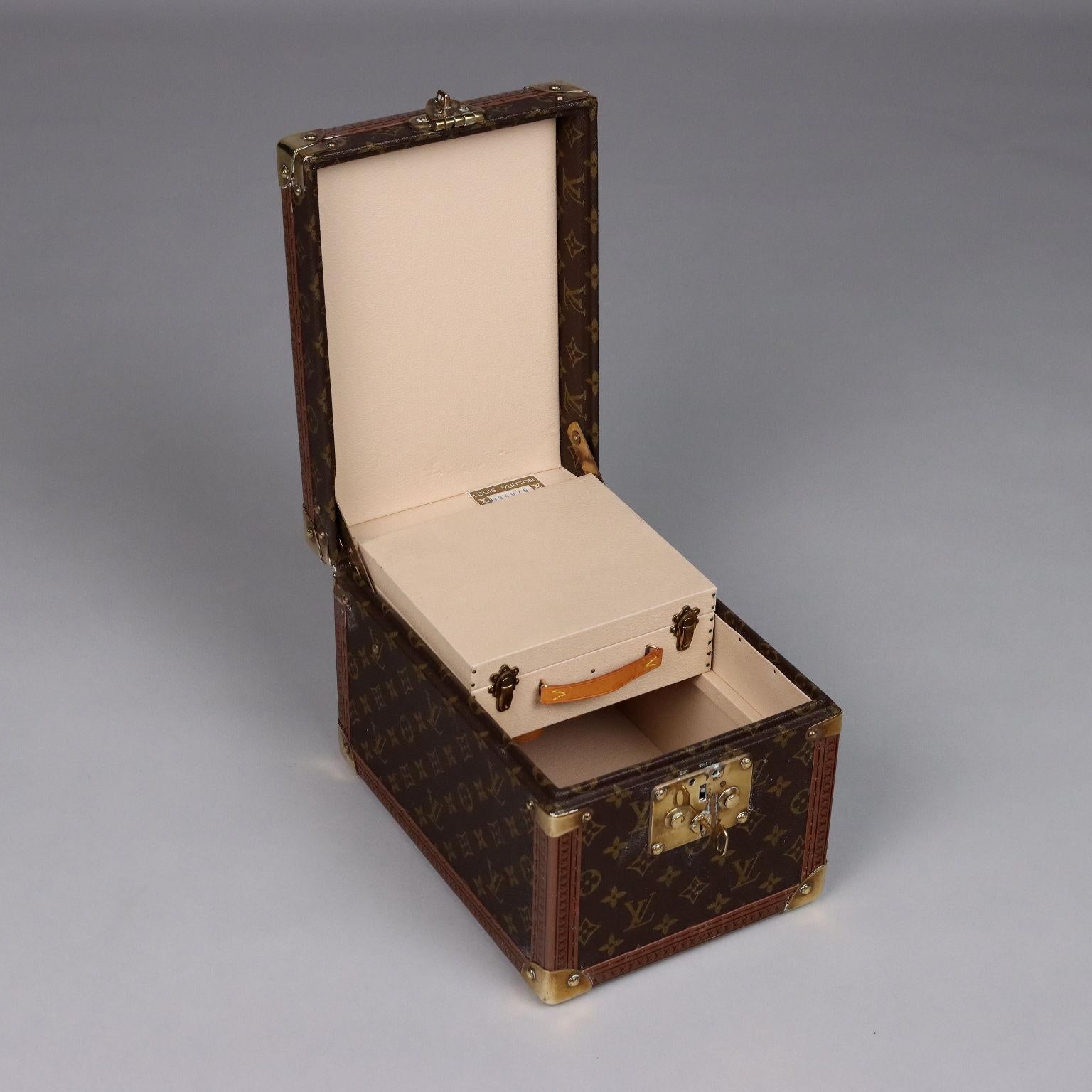 Louis Vuitton travel beauty case covered in Monogram canvas. Hardware is brass, studs are branded. Interior fitted with case with mirror, leather loops for bottles and original label bearing unique product number (984075). Key present. Small marks