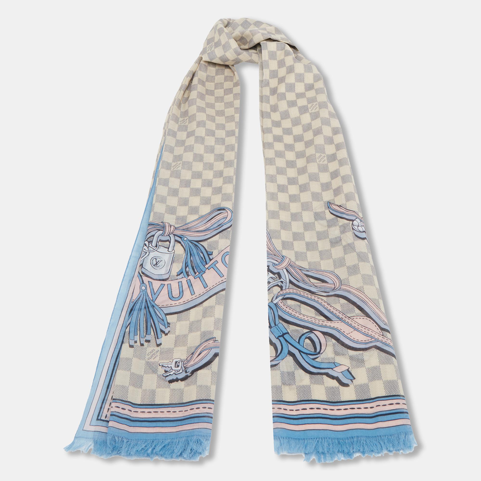 Classy and luxurious are some words that come to our minds when we think of Louis Vuitton. The label brings you this scarf made from cotton in a blue and beige shade and has the Azur pattern as well as LV strap prints all over.

