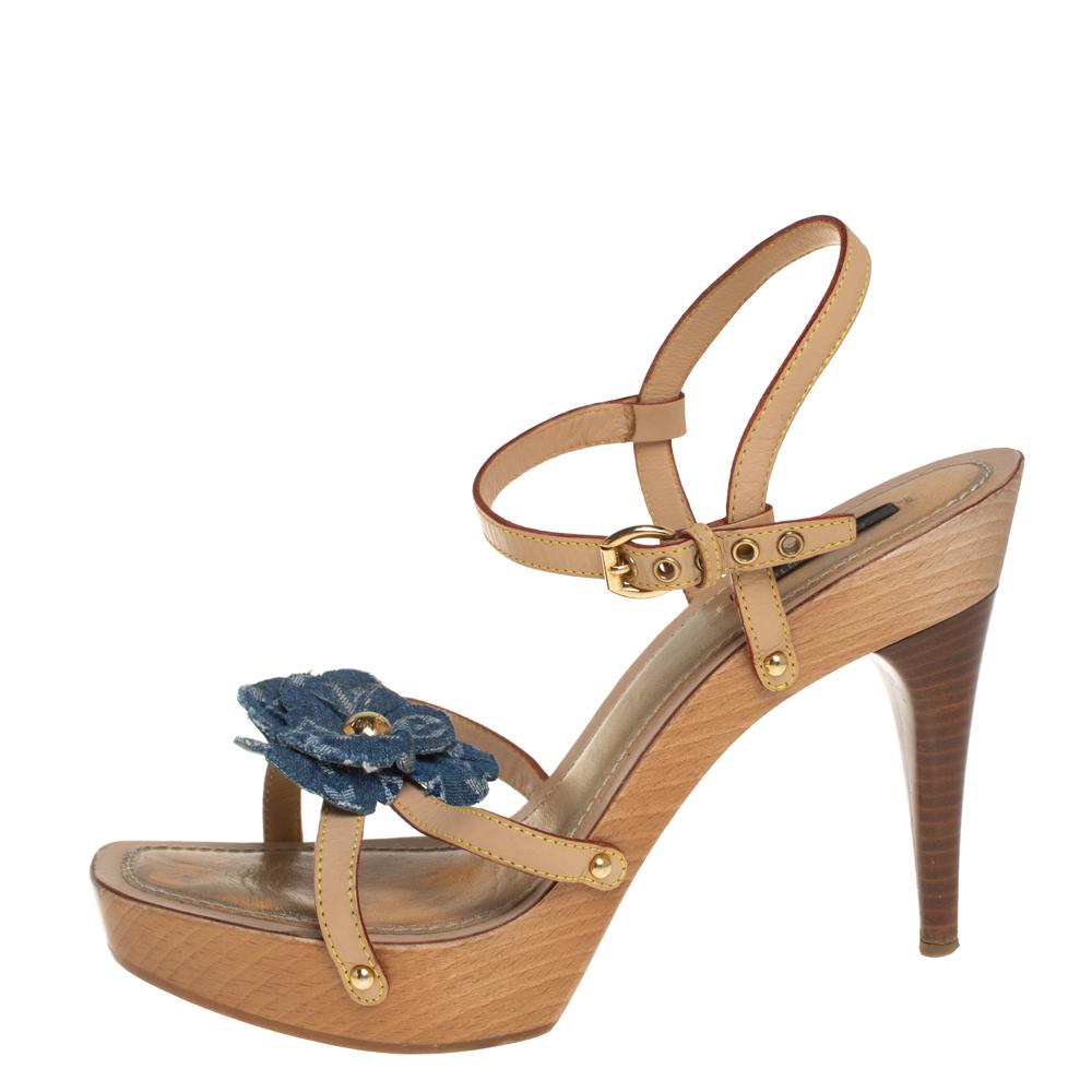 Straps in beige leather have been used to form this gorgeous pair by Louis Vuitton. The strappy layout, monogram denim flower detail, open toe, and ankle strap closure are added to frame your feet in an alluring way. Leather-lined insoles and 12 cm