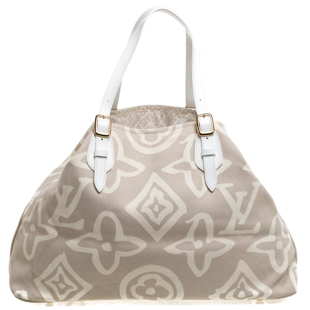This special creation is for all Louis Vuitton collectors and lovers alike. Meticulously crafted from beige canvas, this dream bag is held by two leather handles with buckles and decorated with a subtle interpretation of their signature monogram all
