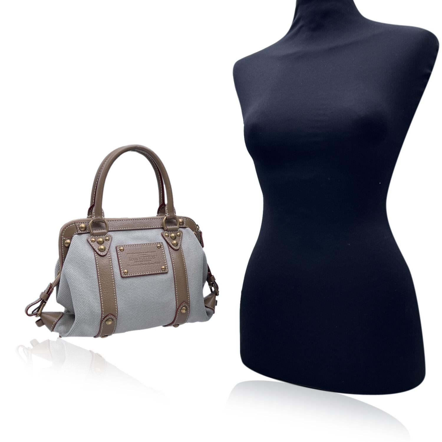 Louis Vuitton Limited Edition' Sac de Nuit MM' crafted in beige Trianon Canvas with tan Suhali genuine leather trim and handles. From the Spring-Summer 2004 collection. The bag features the hystorical 'Inventeur' logo patch in leather. Gold metal
