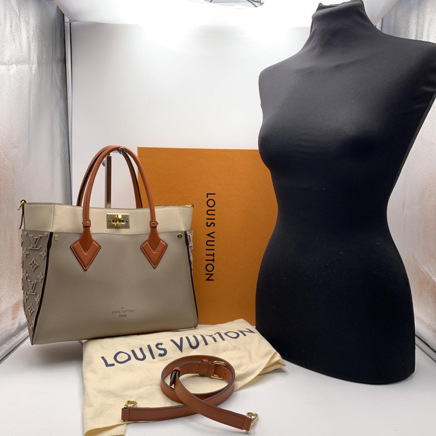 This beautiful Bag will come with a Certificate of Authenticity provided by Entrupy. The certificate will be provided at no further cost

Louis Vuitton 'On my Side' Tote Bag, crafted in beige and taupe leather with embossed monogram pattern on the