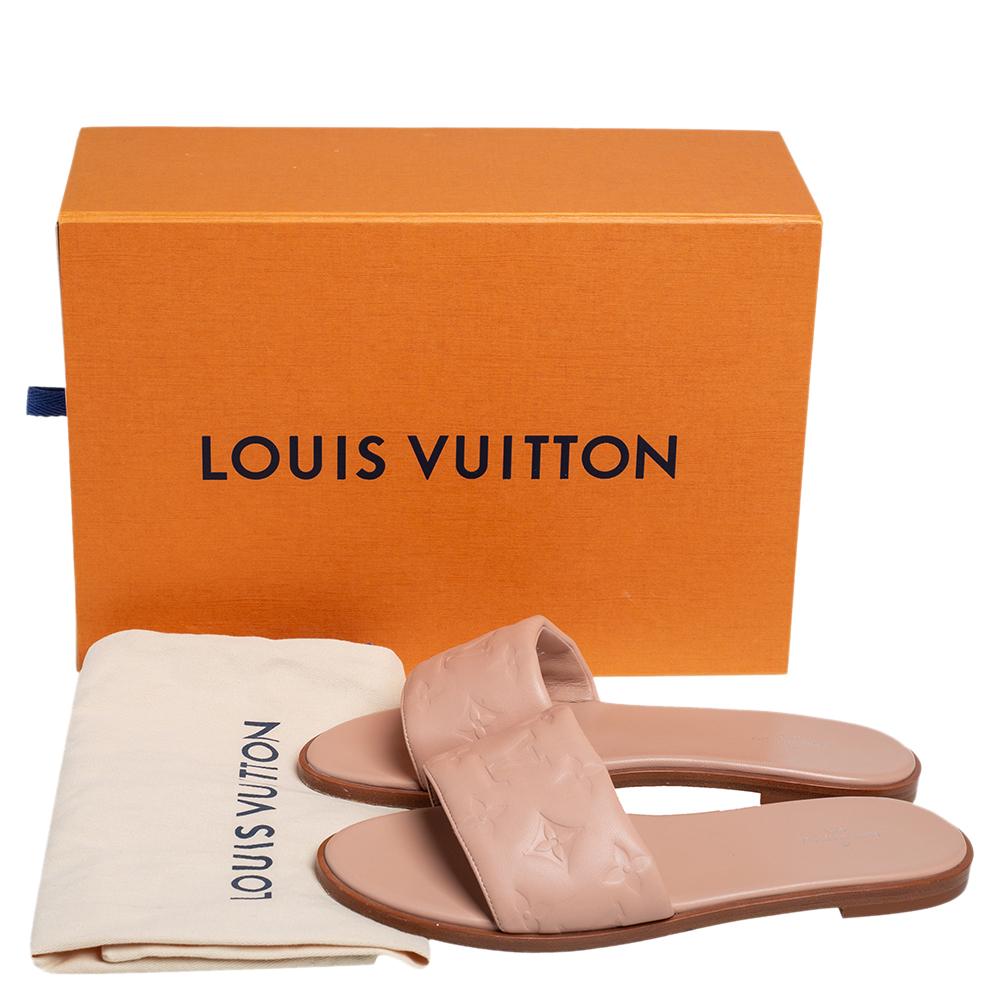 These Revival flats hail from the house of Louis Vuitton. They have been crafted from Monogram-embossed leather and come in a classic shade of beige. They have open toes, short heels, and durable leather soles & insoles.

Includes: Original Box,