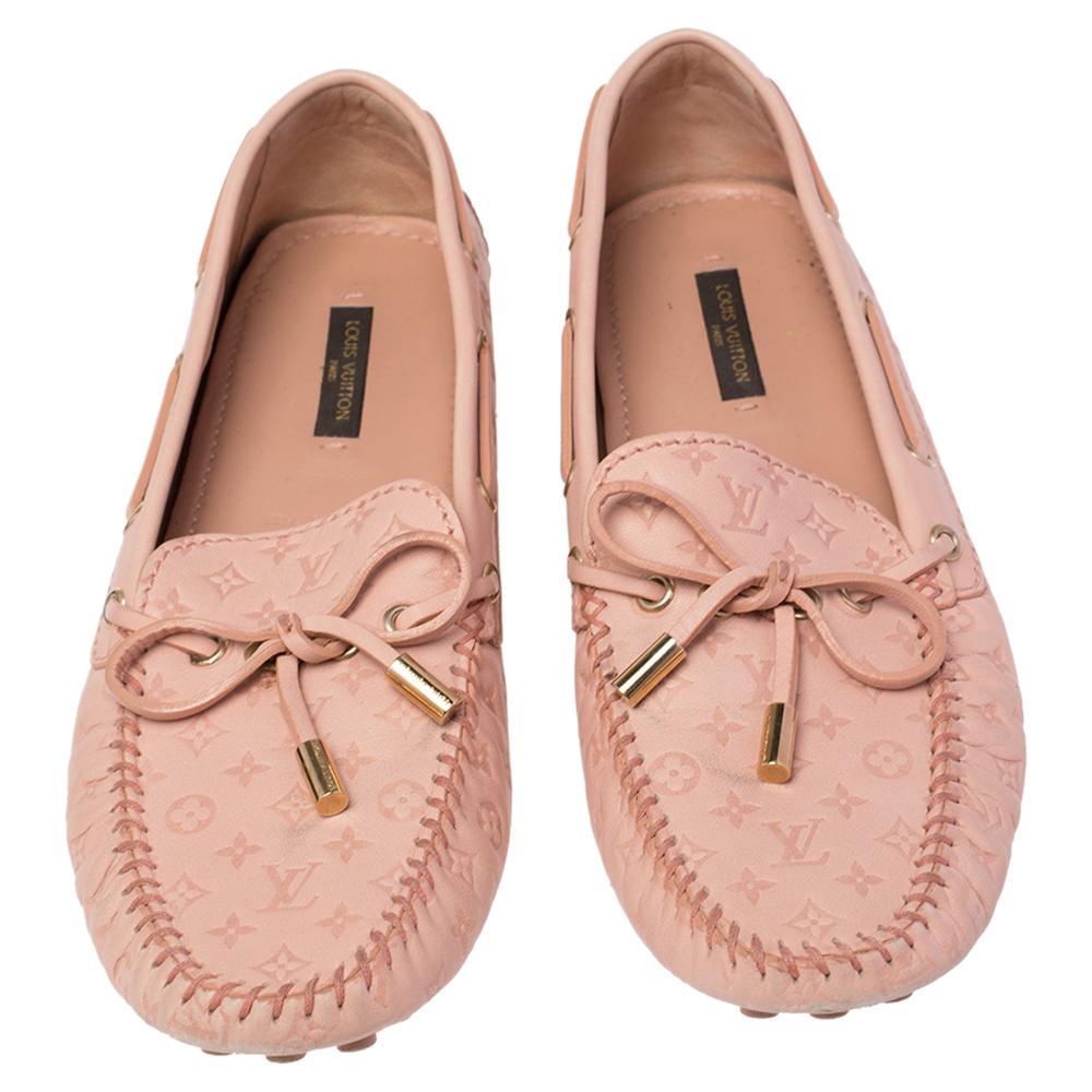 To perfectly complement your attires, Louis Vuitton brings you this pair of loafers that speak nothing but style. They've been crafted from beige leather embossed with the signature Mongram and styled with ties on the uppers. The comfortable loafers