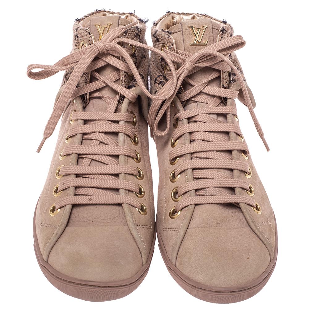 This comfortable pair of Brea sneaker boots is by Louis Vuitton. The sneakers are crafted from nubuck and feature the signature monogram canvas on the tweed high-top. The round-toe shoes have lace-up fronts and leather-lined insoles.

Includes: