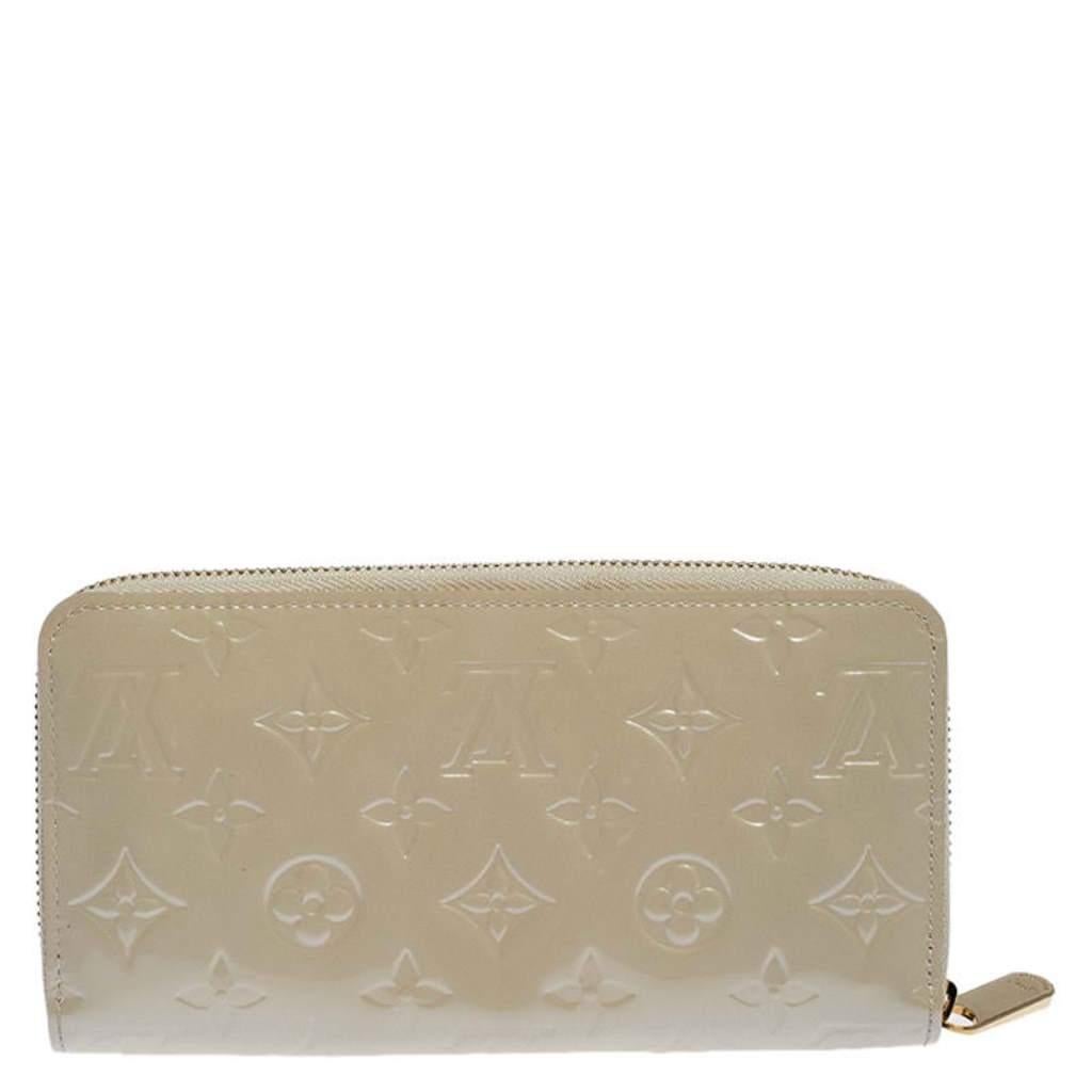 This Louis Vuitton Zippy wallet is conveniently designed for everyday use. Crafted from Monogram Vernis leather, the wallet has a zip closure which opens to reveal multiple slots, leather-fabric compartments and a zip pocket for you to neatly