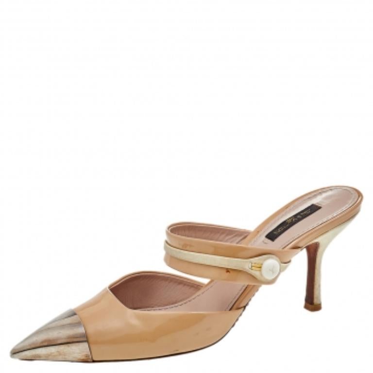 From Louis Vuitton comes this pair of chic mules to guide your steps with comfort and style. Crafted using patent leather, the mules have metal pointed-toe caps. suede trims, and 8 cm heels.