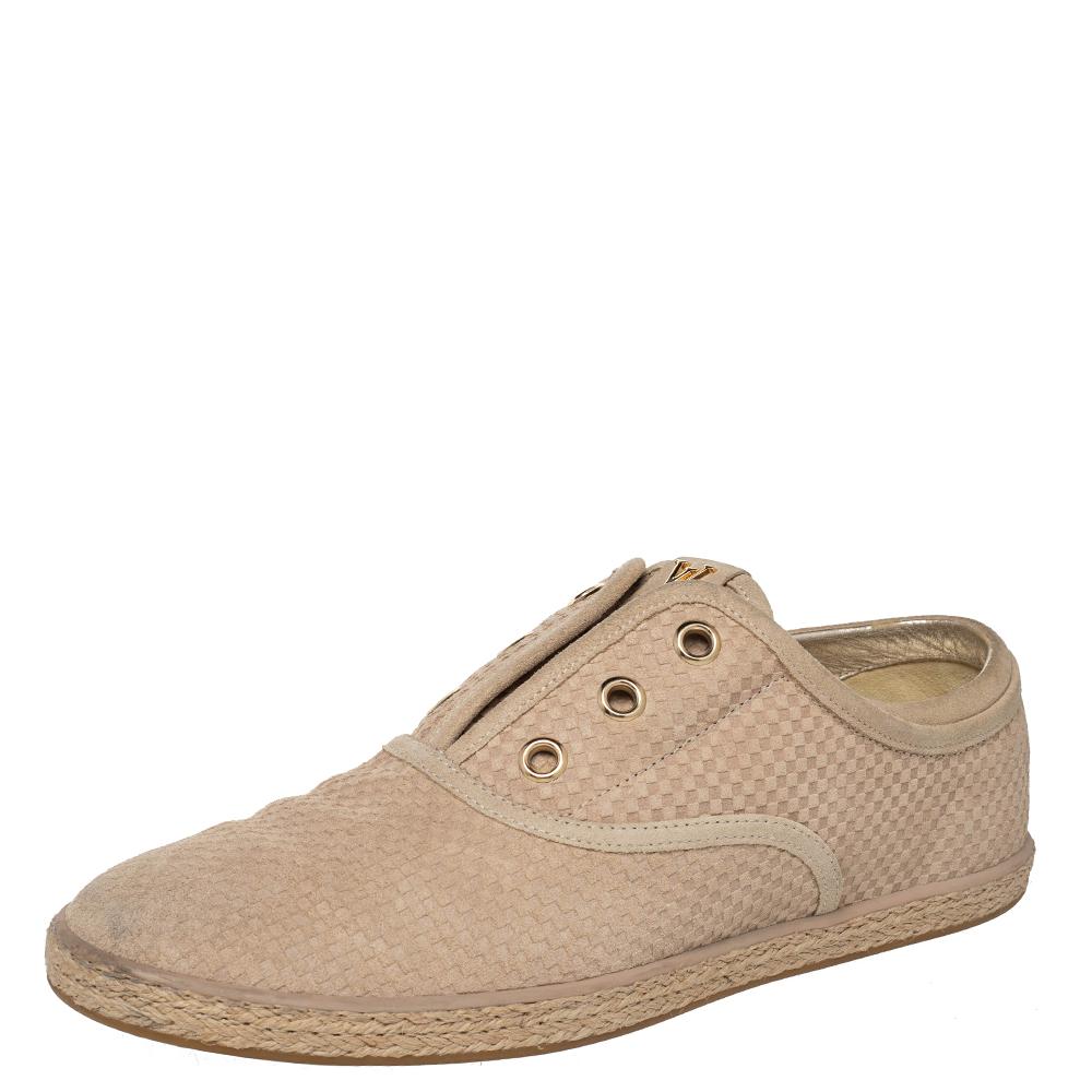 Make these Louis Vuitton shoes your favorite everyday piece. Crafted from suede, they have a distinct exterior in a shade of beige coupled with a Petit Damier print and matched with espadrilles outer soles. They feature golden LV logos on the
