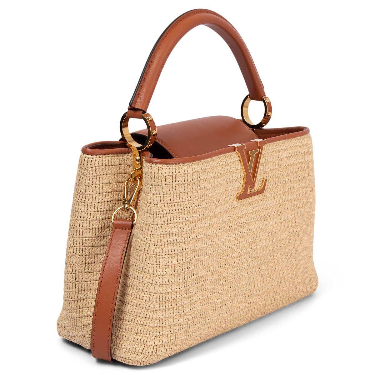 100% authentic Louis Vuitton Capucines MM bag is made from braided raffia and smooth caramel cowhide leather on the handle, trim and strap featuring gold-tone hardware. Opens with a flap to a compartmented interior with a zipped pocket against the