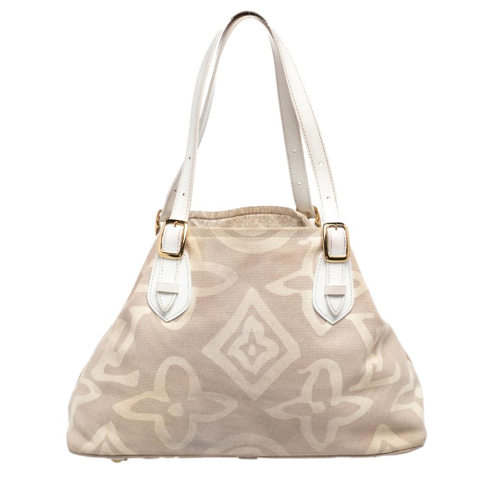 This special creation is for all Louis Vuitton collectors and lovers alike. Meticulously crafted from beige canvas, this dream bag is held by two handles with buckles and decorated with a subtle interpretation of their signature monogram all over in