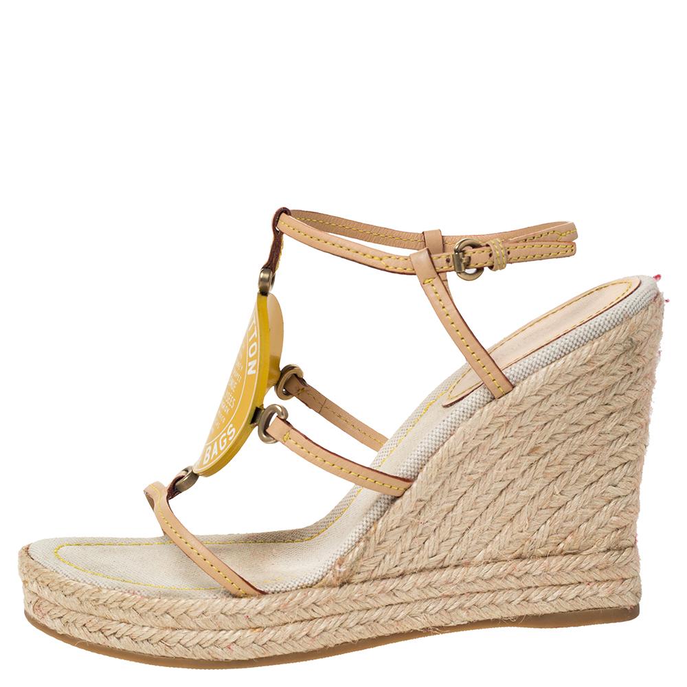 Designed with leather straps in beige and detailed with a signature patch on the front, these sandals by Louis Vuitton are meant to offer style, especially on days when you have to spend long hours outdoors. They are set on espadrille wedge heels